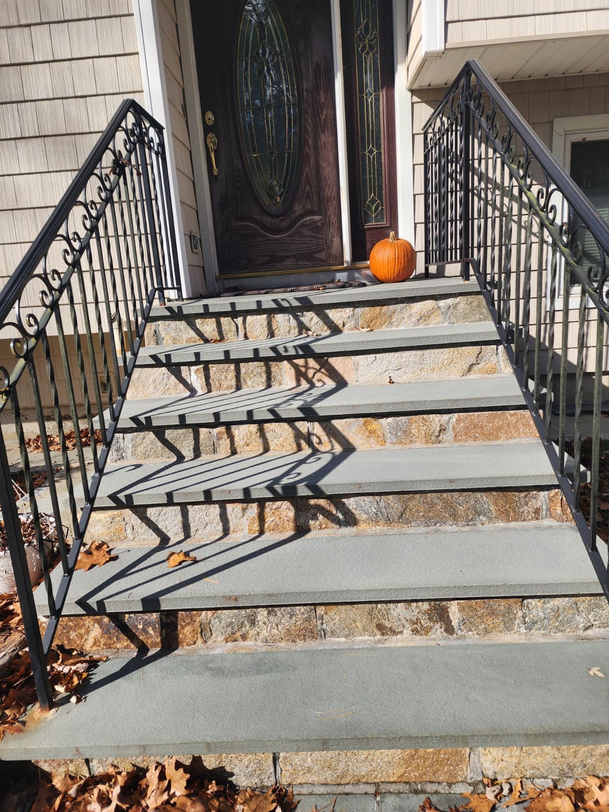 Bluestone steps with stone risers — Connecticut Bluestone steps with stone risers and a wrought-iron railing at a front entrance