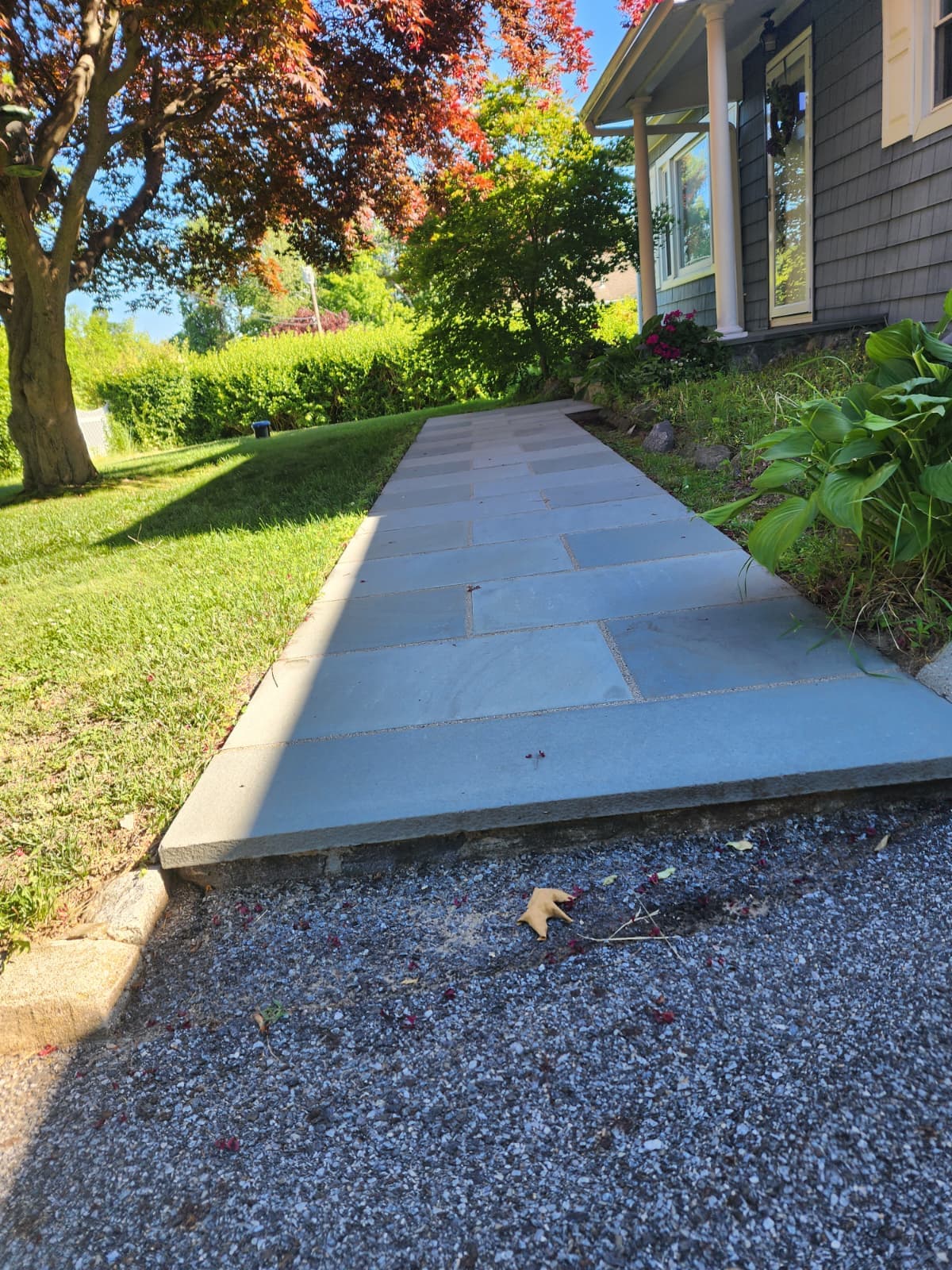 Bluestone walkway — Connecticut Bluestone walkway bordered by lawn leading along the side of a home