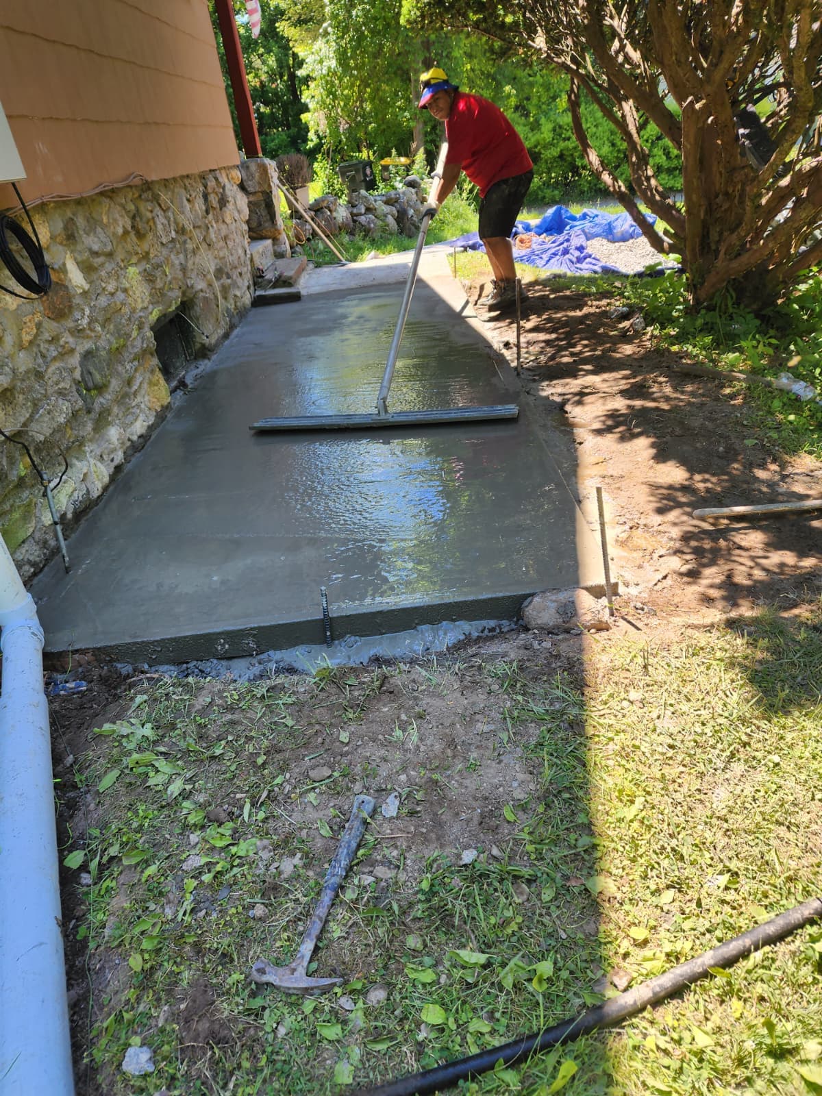 Concrete walkway pour — Connecticut Freshly poured and floated concrete walkway beside a stone foundation